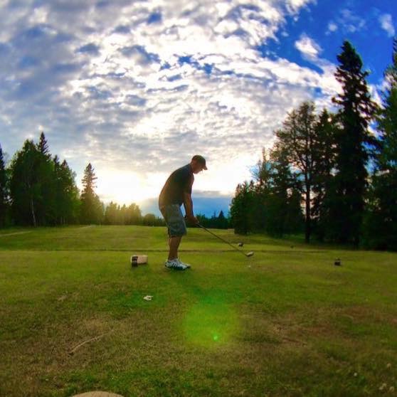 Golfer teeing off